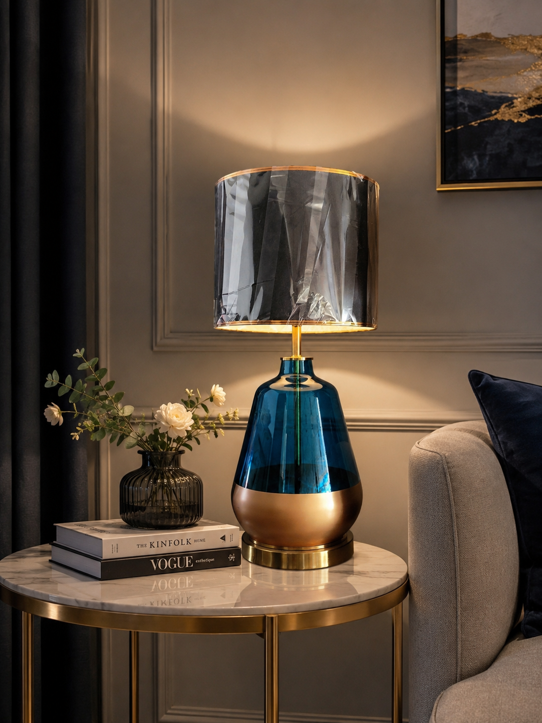Blue Glass and Gold Base Luxury Table Lamp with smoked drum shade on marble side table