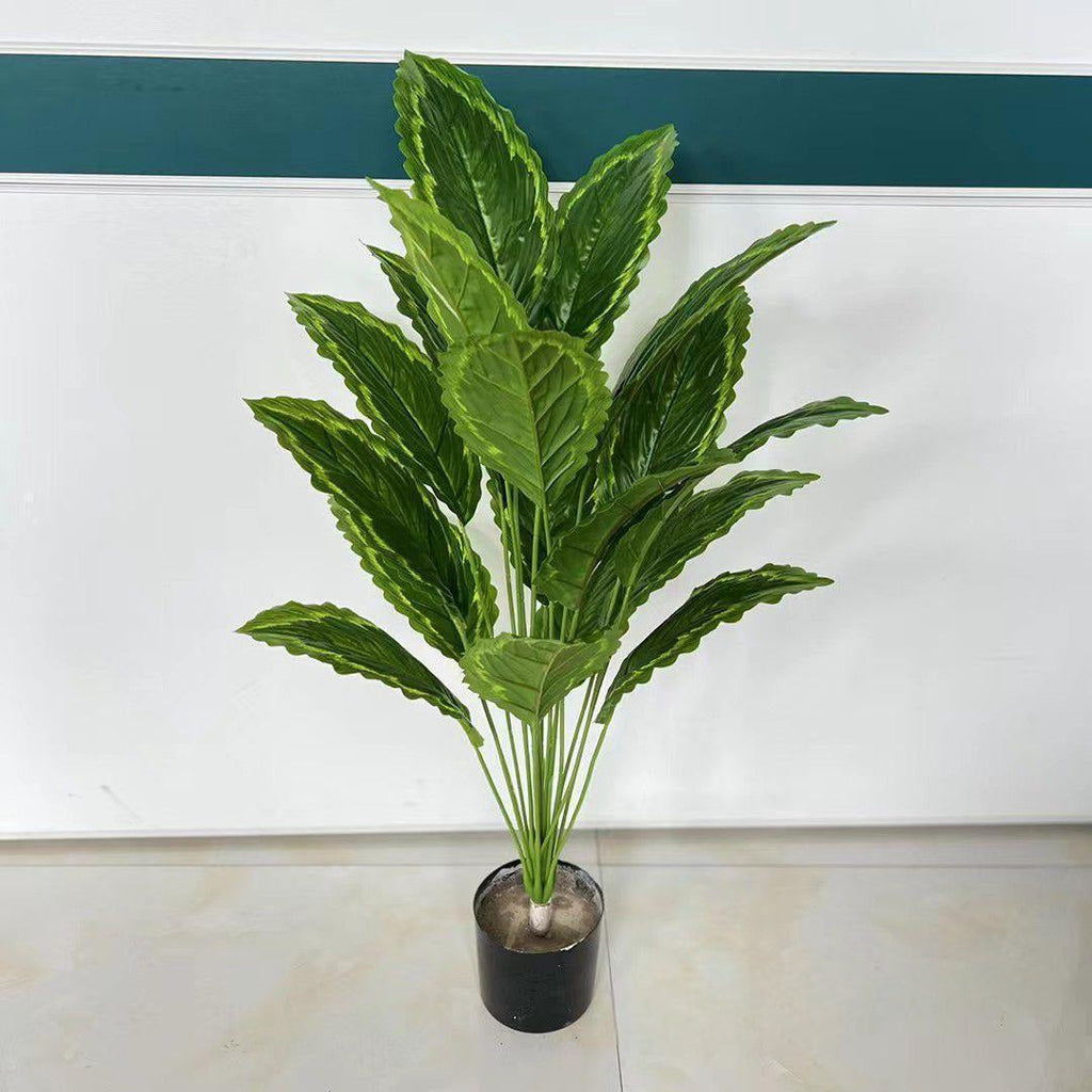 Artificial burgundy dark leaf tropical plant in black pot