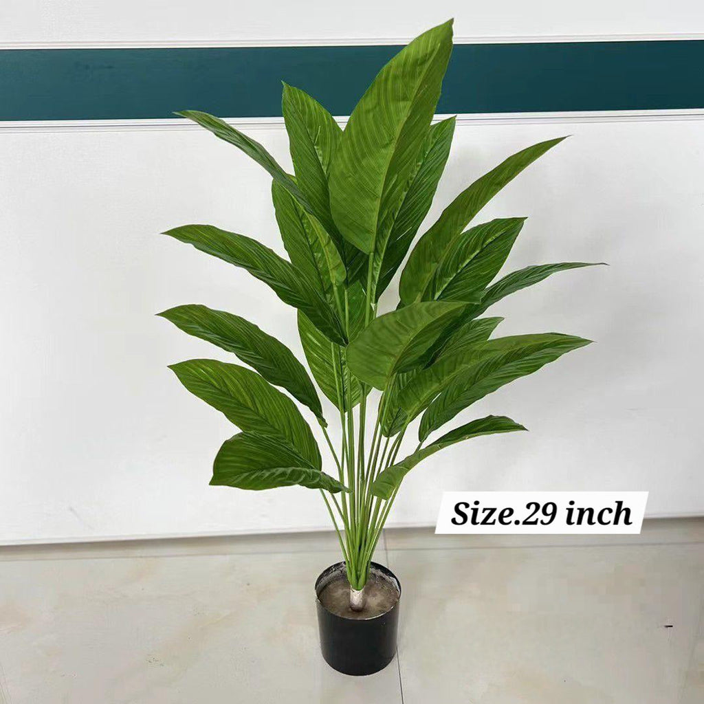 Artificial large leaf green tropical plant in black pot