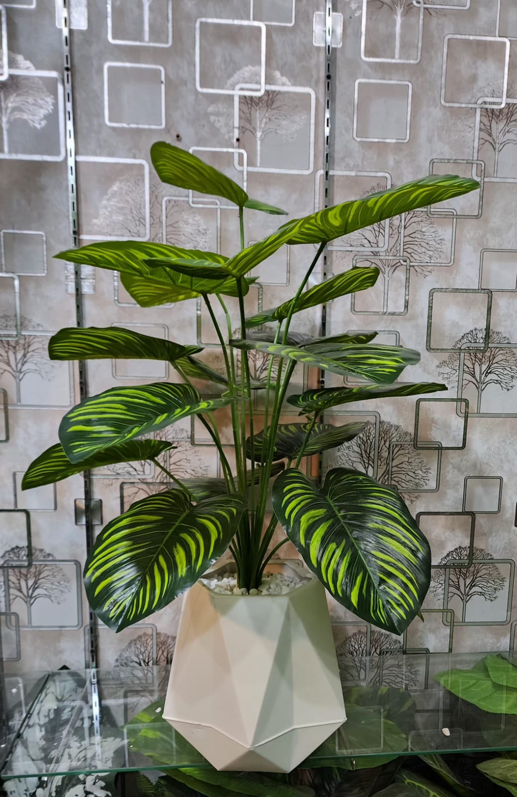 Artificial Calathea plant with striped leaves in white geometric pot