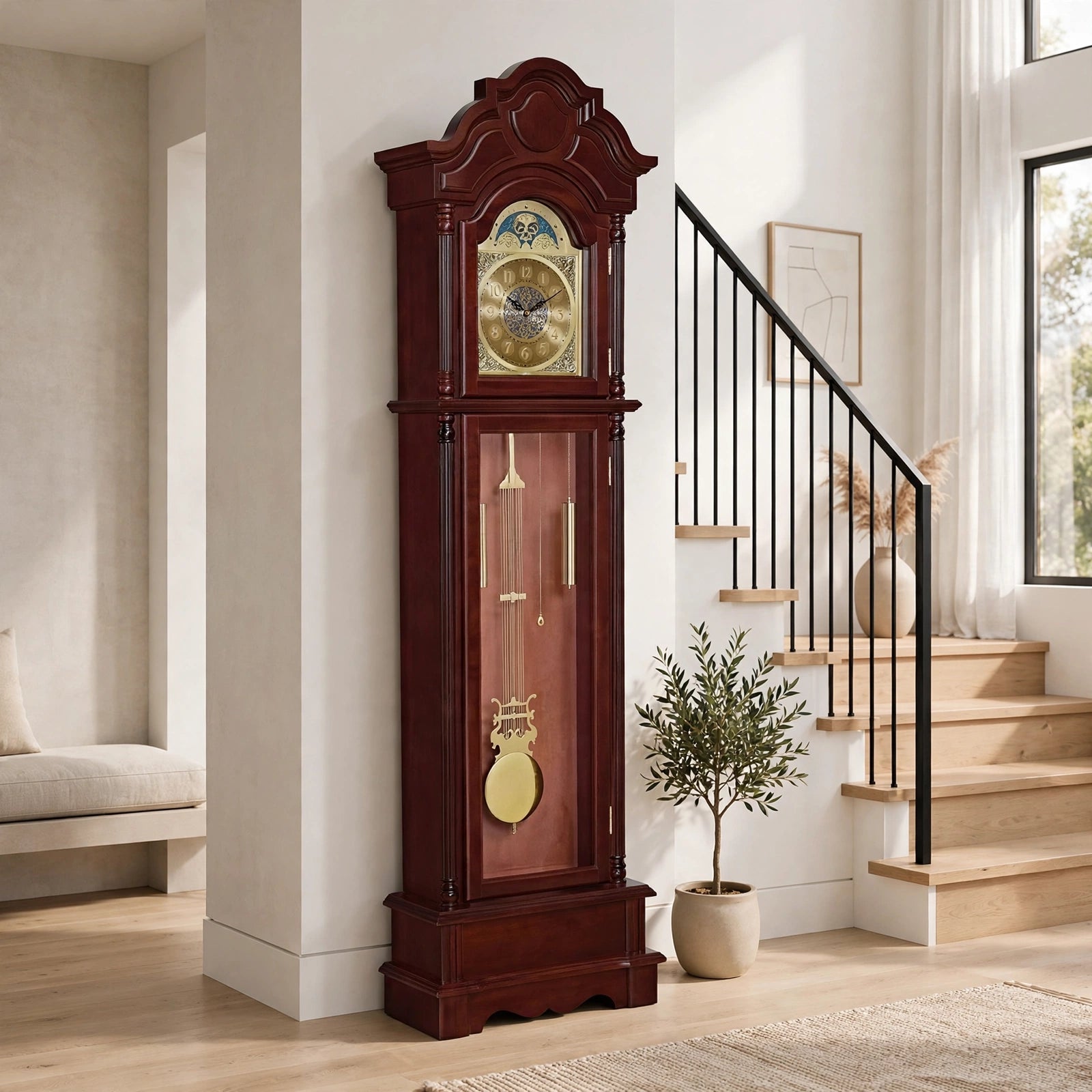 Mahogany grandfather clock with moon phase dial and gold pendulum displayed in a modern home entryway