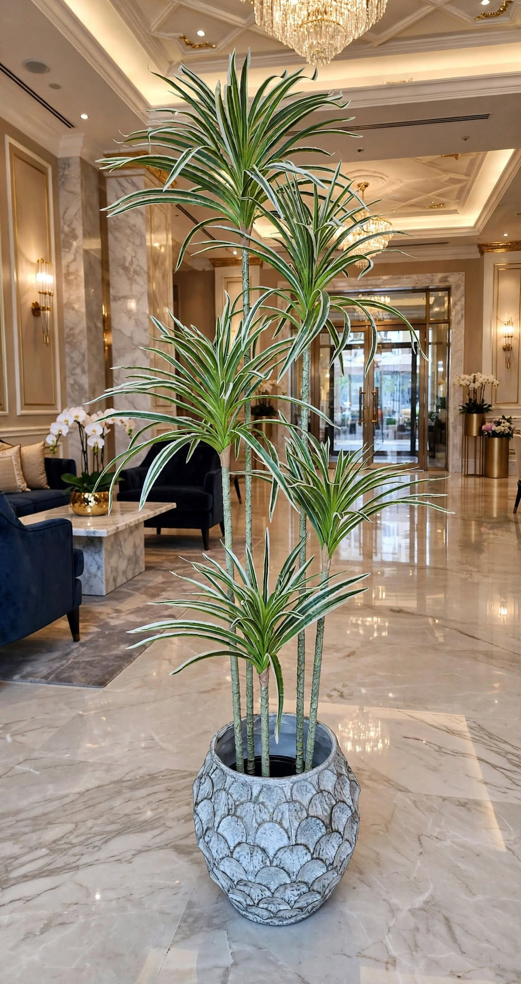 Artificial Dracaena plant styled in a luxury office setting next to a wooden desk
