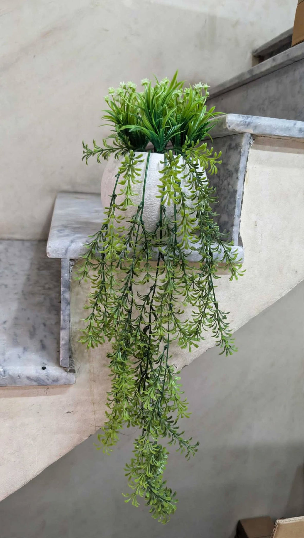 Artificial hanging plant with white flowers in white pot