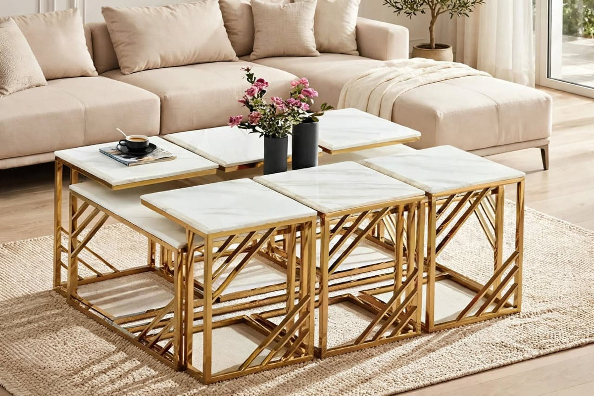 Gold-toned and white-look accent tables styled in a living room