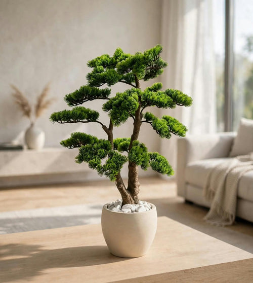 Bonsai-style decorative tree in a white pot on a table