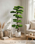 48 inch artificial bonsai tree in white planter in a modern living room
