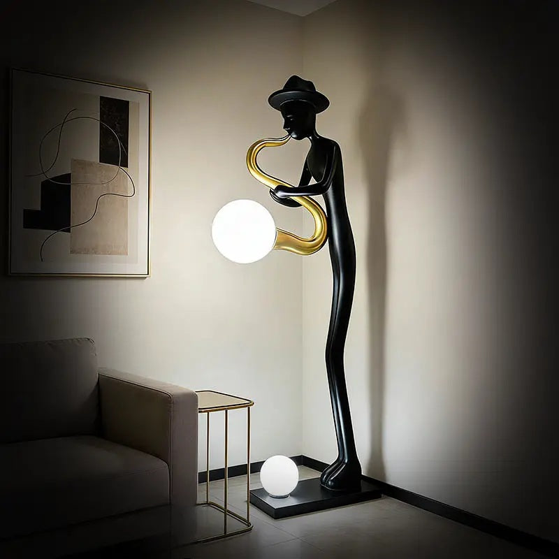Black saxophone player floor lamp with gold saxophone and glowing white orb