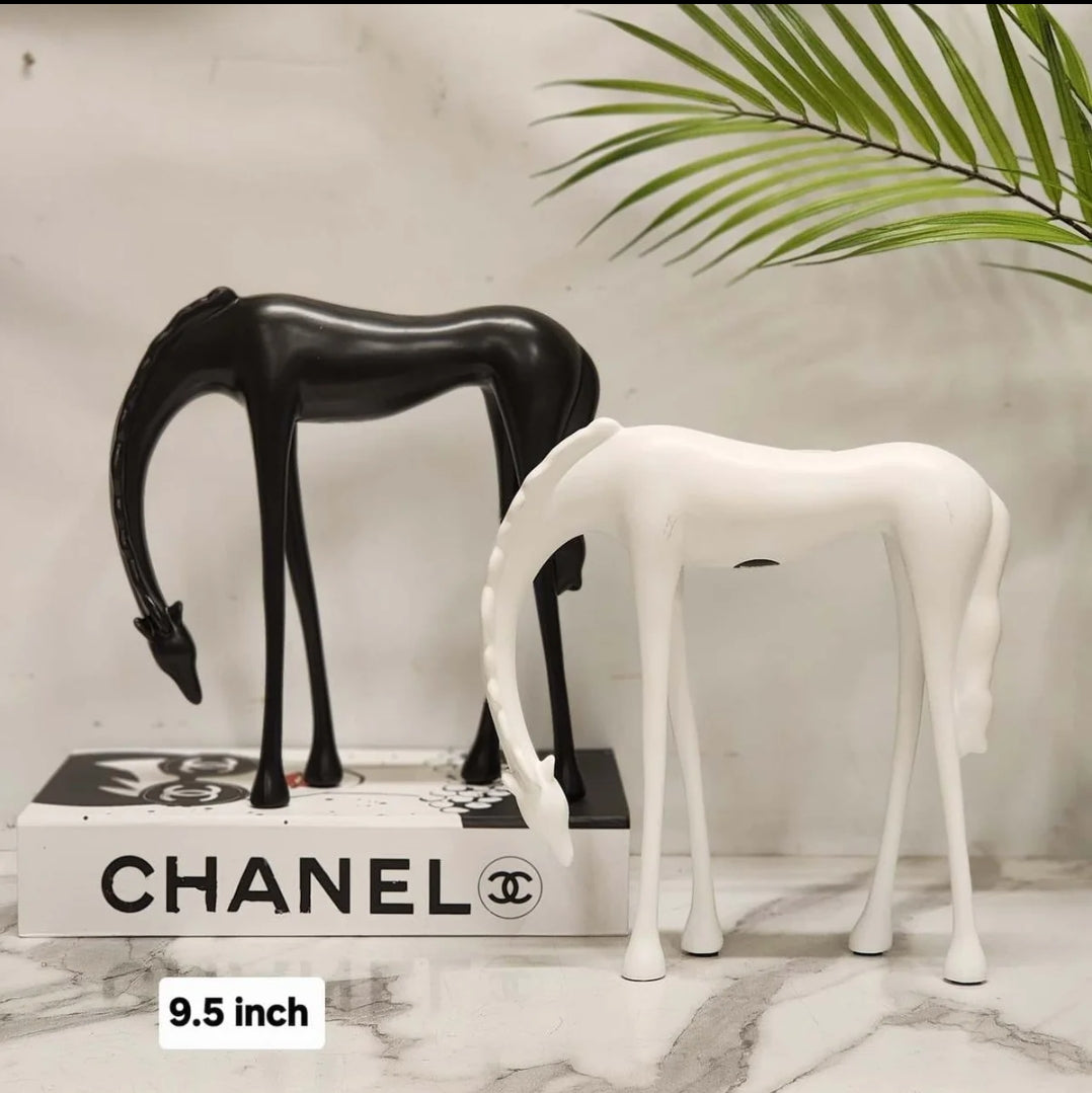 Abstract grazing horse figurine 9.5 inch in matte black and white on marble surface