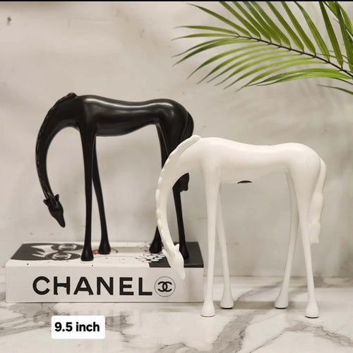 Abstract grazing horse figurine 9.5 inch in matte black and white on marble surface